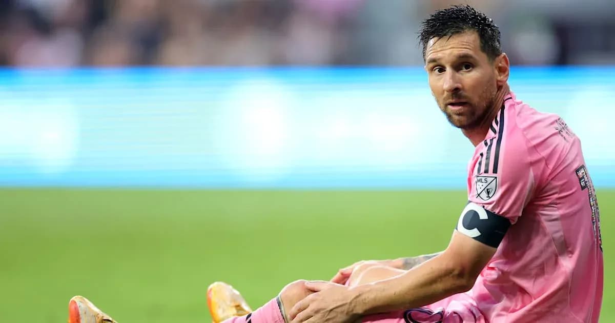 Player sitting on field in pink uniform