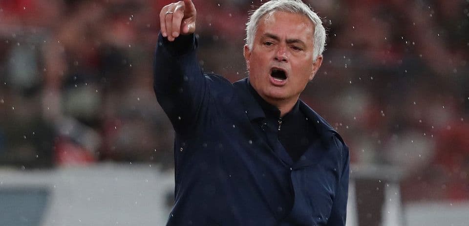 Manager giving instructions during a rainy match