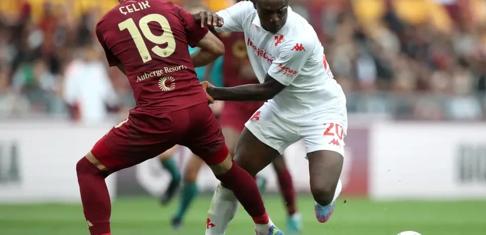 Celik tackling opponent during AS Roma match