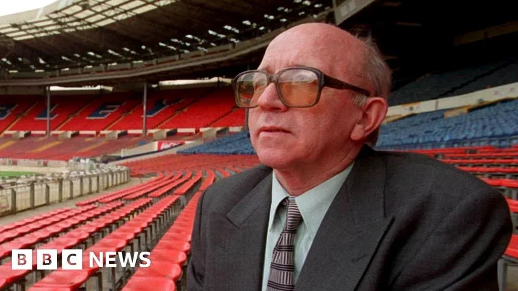 Man sitting in empty stadium with red seats