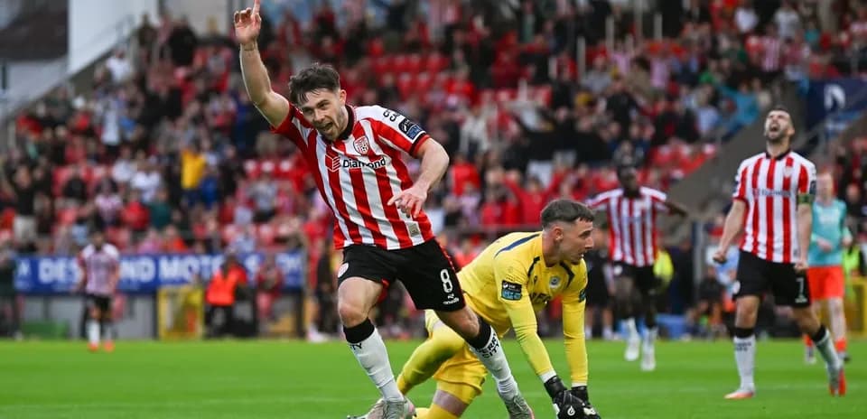 Player celebrating goal with fans in background