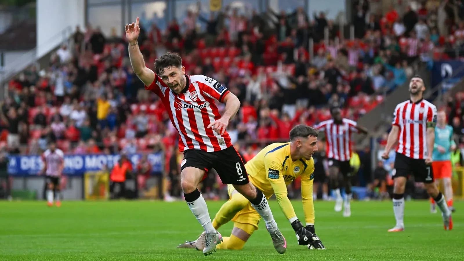Player celebrating goal with fans in background