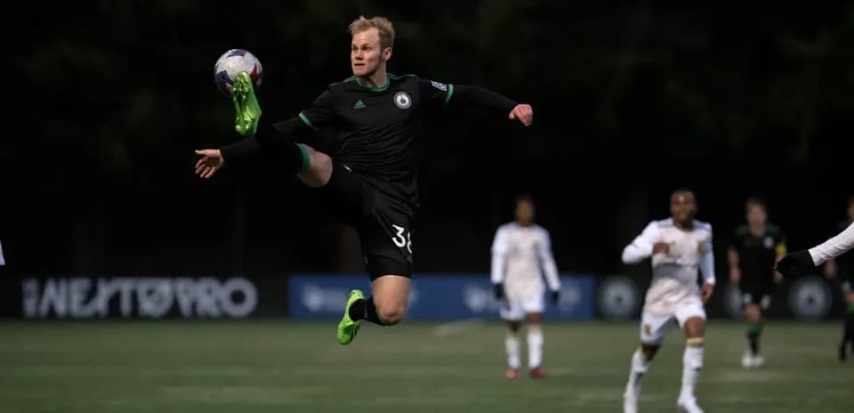 Goalkeeper making a save during football match