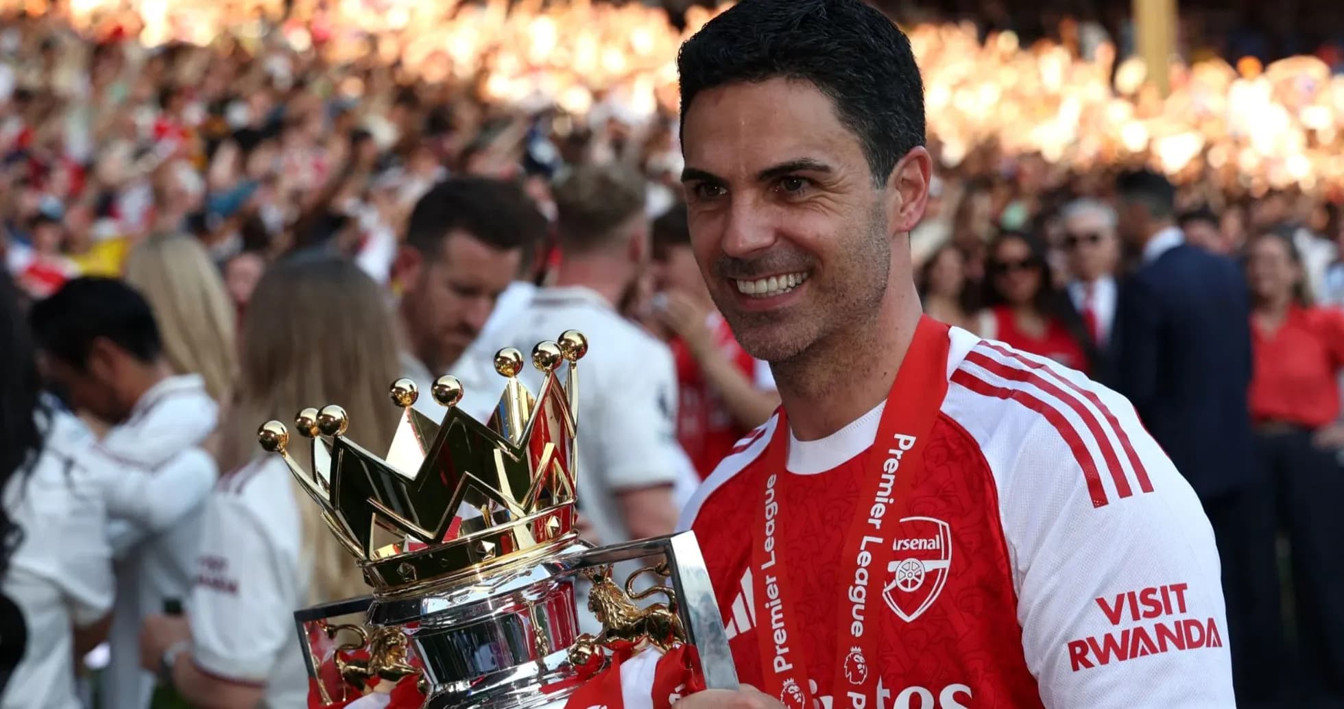 Manager holding Premier League trophy in celebration