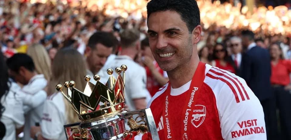 Manager holding Premier League trophy in celebration