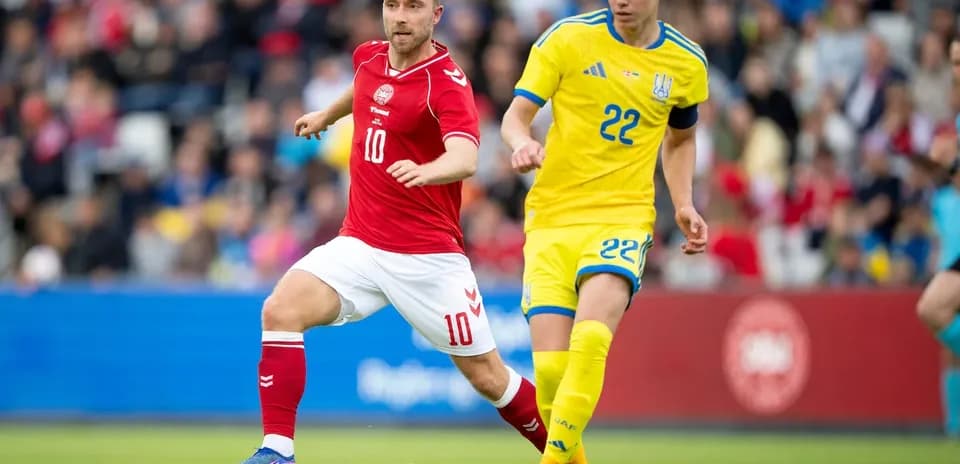 Danish player number 10 and Ukrainian number 22 competing for ball