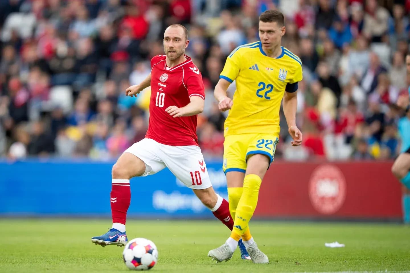 Danish player number 10 and Ukrainian number 22 competing for ball