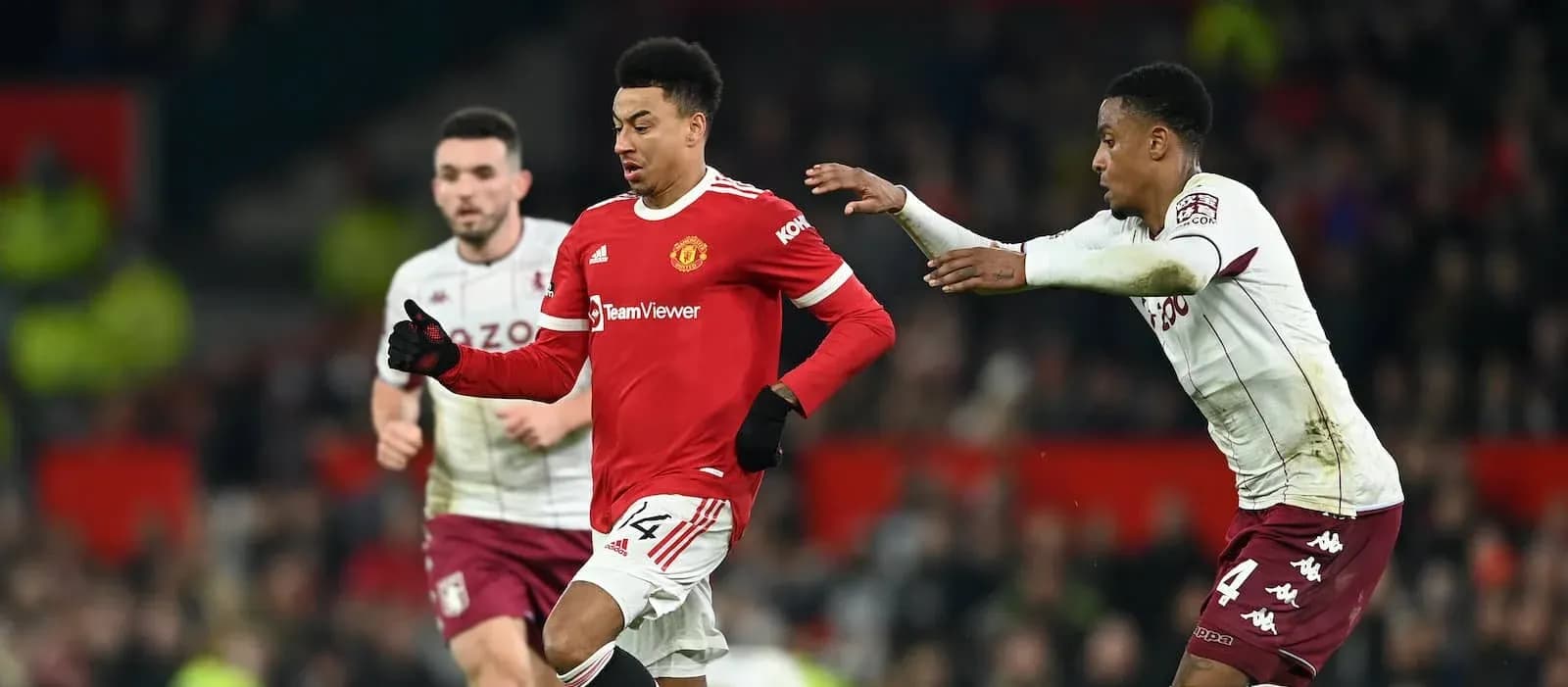 Manchester United player dribbling past Aston Villa opponent Manchester United player dribbling past Aston Villa opponent