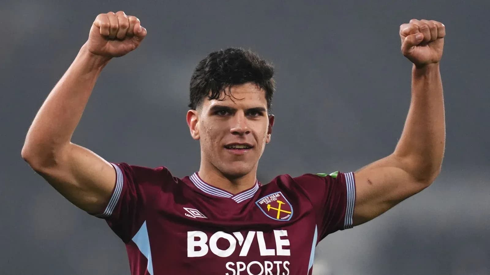 Player celebrating with raised fists in team jersey Player celebrating with raised fists in team jersey
