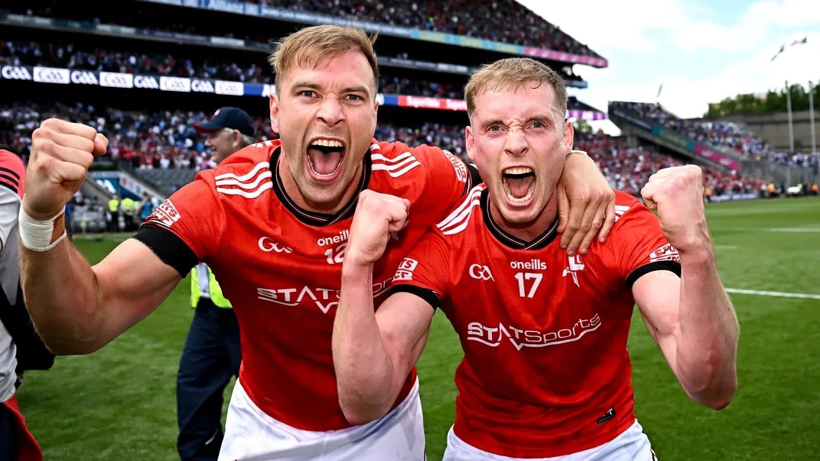 Two players celebrating victory on the pitch Two players celebrating victory on the pitch