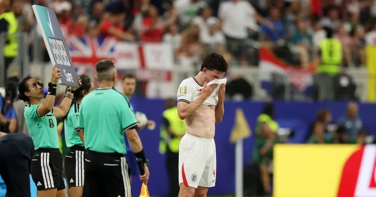 Player leaving field, holding shirt to face Player leaving field, holding shirt to face