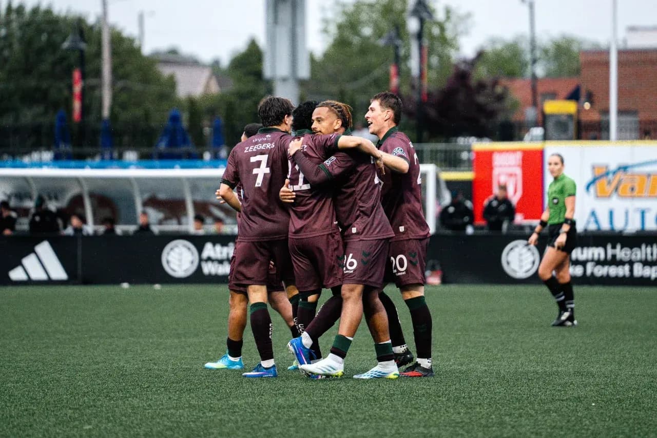 Players celebrating a goal during match Players celebrating a goal during match