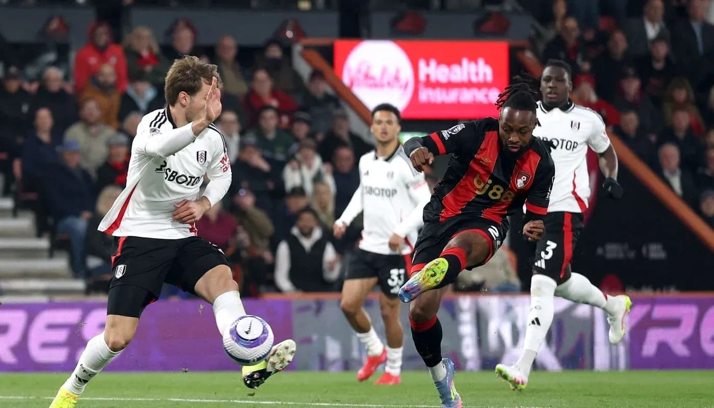 Fulham player challenging Bournemouth opponent for the ball Fulham player challenging Bournemouth opponent for the ball