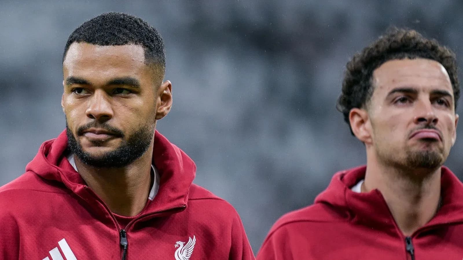 Two Liverpool players in training jackets before match Two Liverpool players in training jackets before match