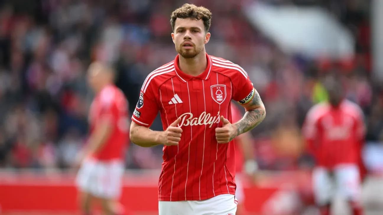 Player in red kit running during match Player in red kit running during match