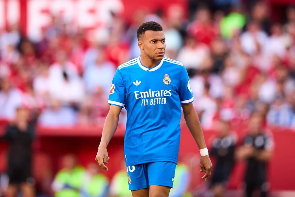 Player in blue Real Madrid kit on the field Player in blue Real Madrid kit on the field