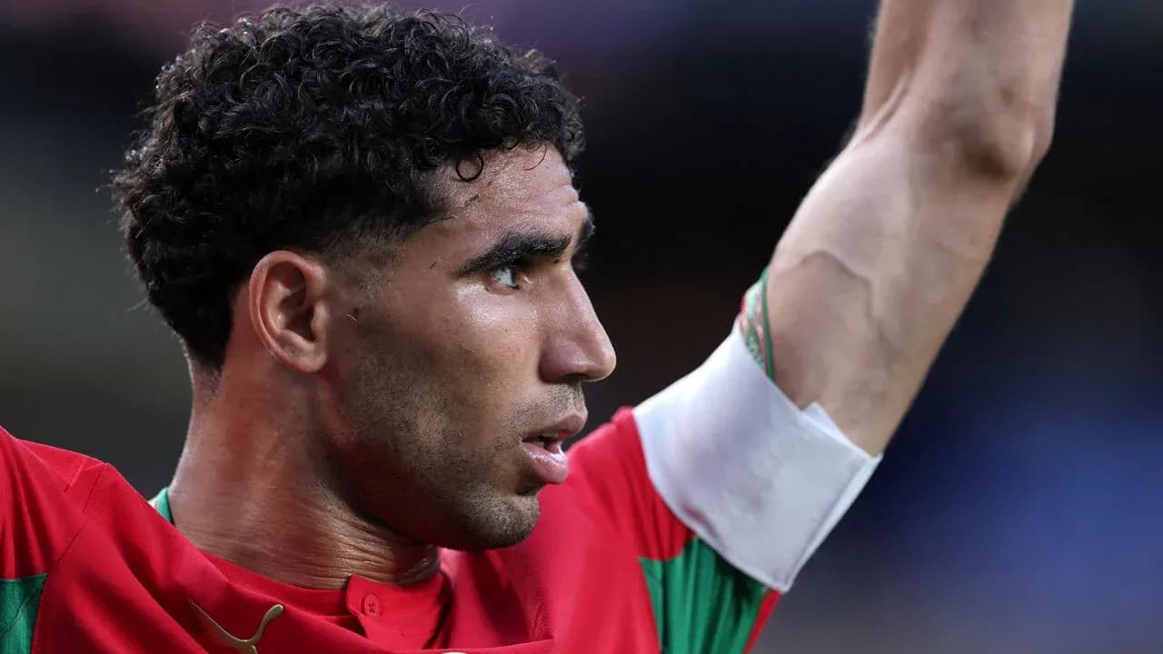 Player celebrating with arm raised in red jersey Player celebrating with arm raised in red jersey