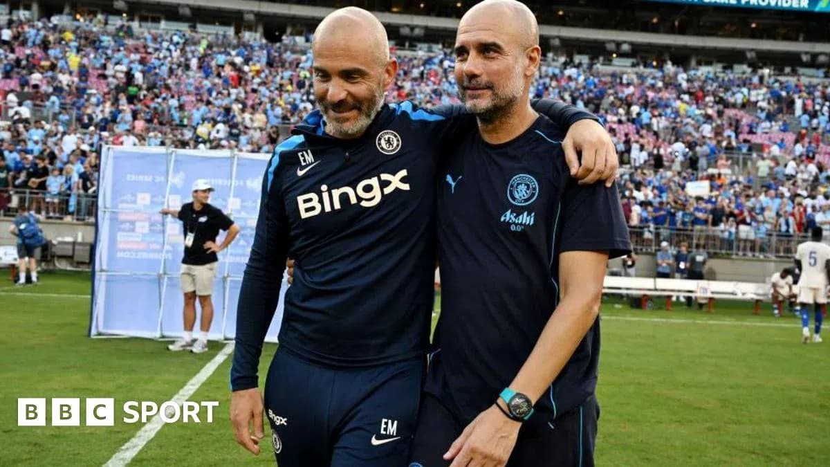 Two coaches embracing on the pitch after match Two coaches embracing on the pitch after match