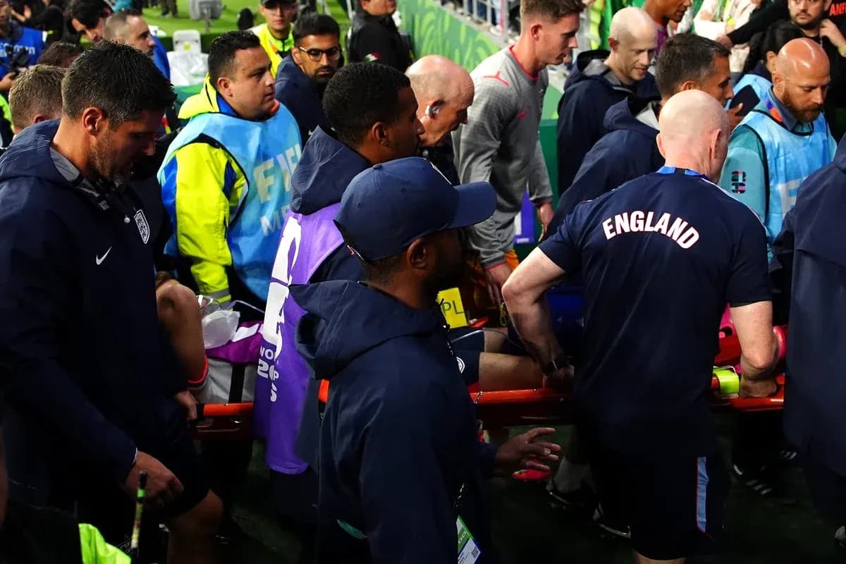 Medical staff attending to injured player on stretcher Medical staff attending to injured player on stretcher