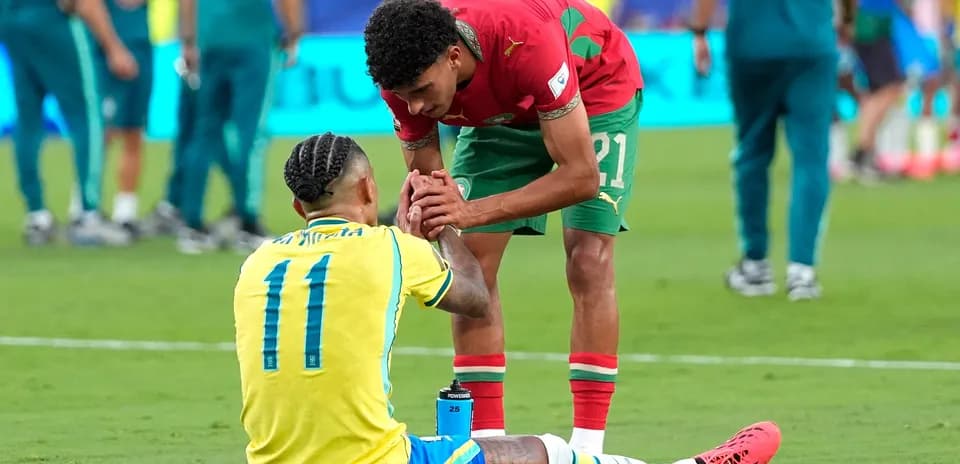 Players from Brazil and Morocco interacting on field Players from Brazil and Morocco interacting on field