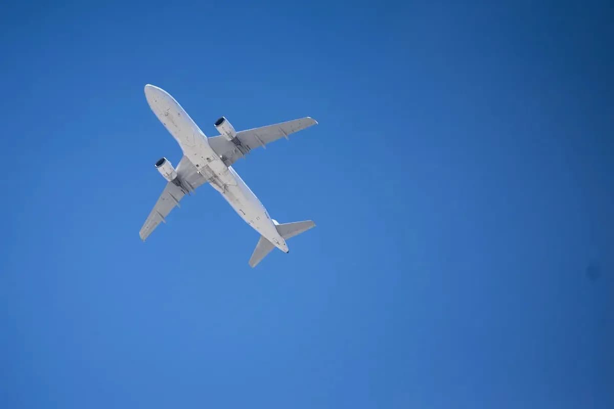 Airplane flying against clear blue sky Airplane flying against clear blue sky