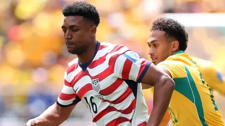 Player in striped jersey running during soccer match Player in striped jersey running during soccer match