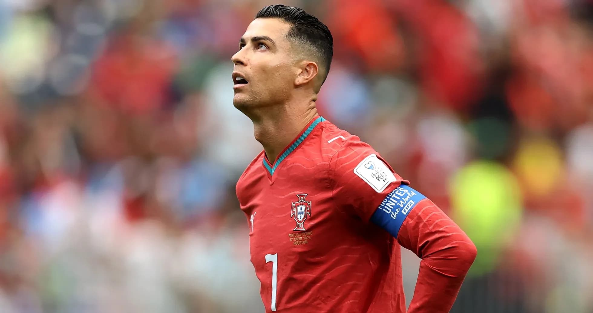 Player looking up during a match in red jersey Player looking up during a match in red jersey