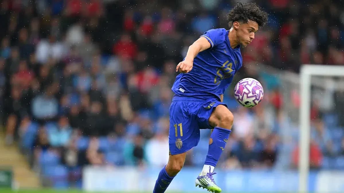 Player in blue jersey dribbling ball during match Player in blue jersey dribbling ball during match