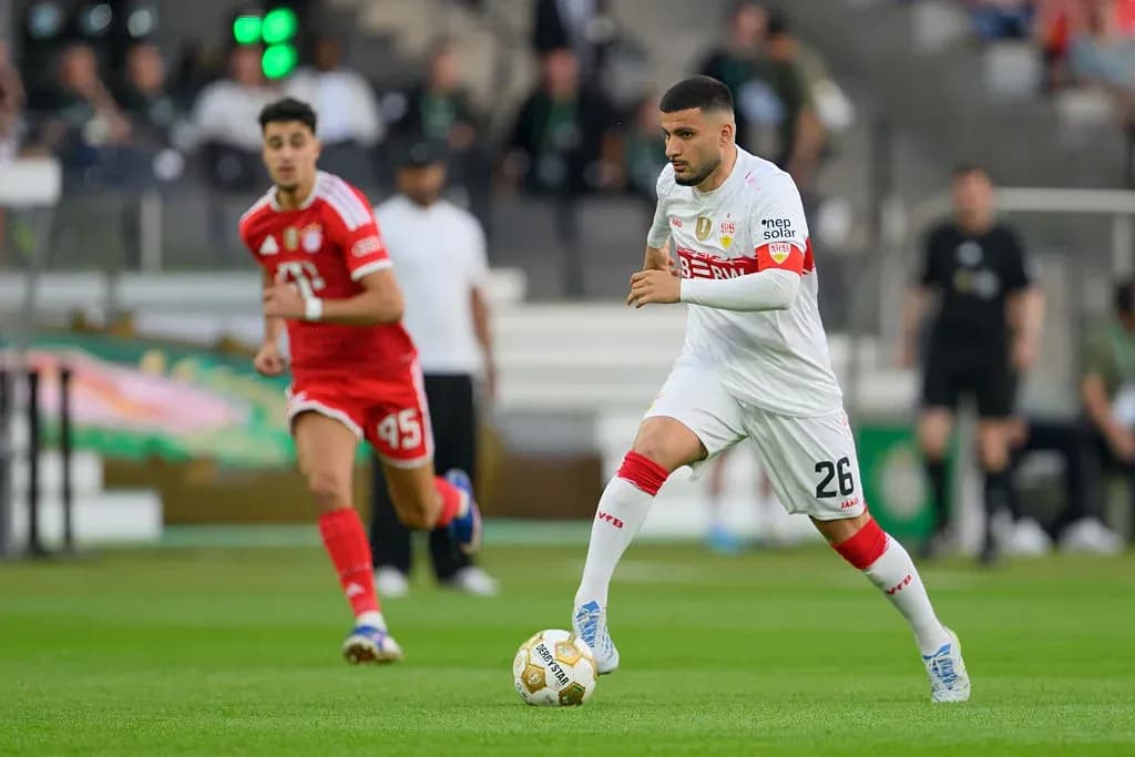Player dribbling ball during a soccer match Player dribbling ball during a soccer match