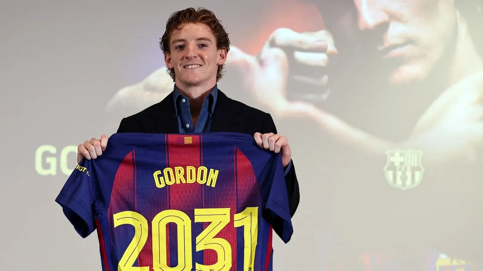 Player holding FC Barcelona jersey with 'Gordon' and '2031' Player holding FC Barcelona jersey with 'Gordon' and '2031'