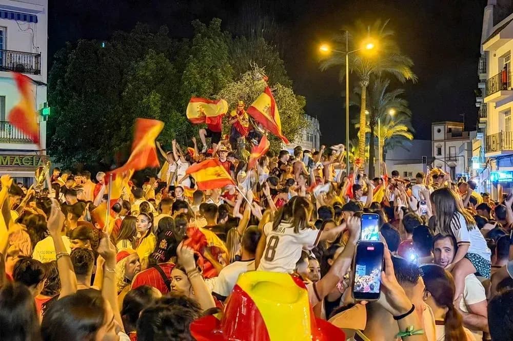 Crowd celebrating with flags in city street Crowd celebrating with flags in city street