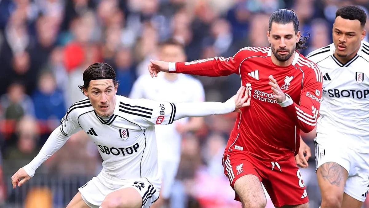 Fulham and Liverpool players competing for the ball Fulham and Liverpool players competing for the ball