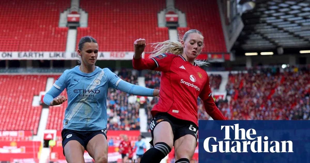 Manchester United and Manchester City players contesting the ball Manchester United and Manchester City players contesting the ball