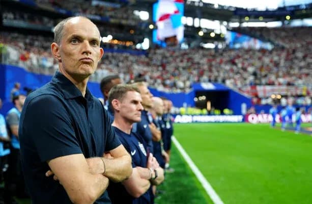 Coach observing match from sideline with staff Coach observing match from sideline with staff