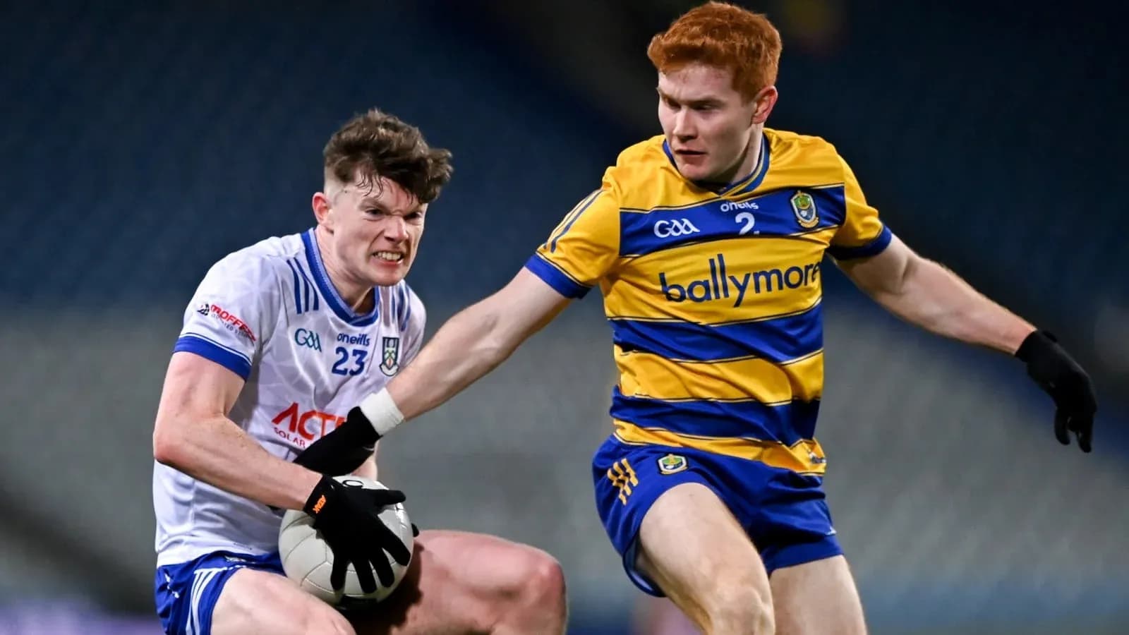 Two players contesting for the ball in Gaelic football Two players contesting for the ball in Gaelic football
