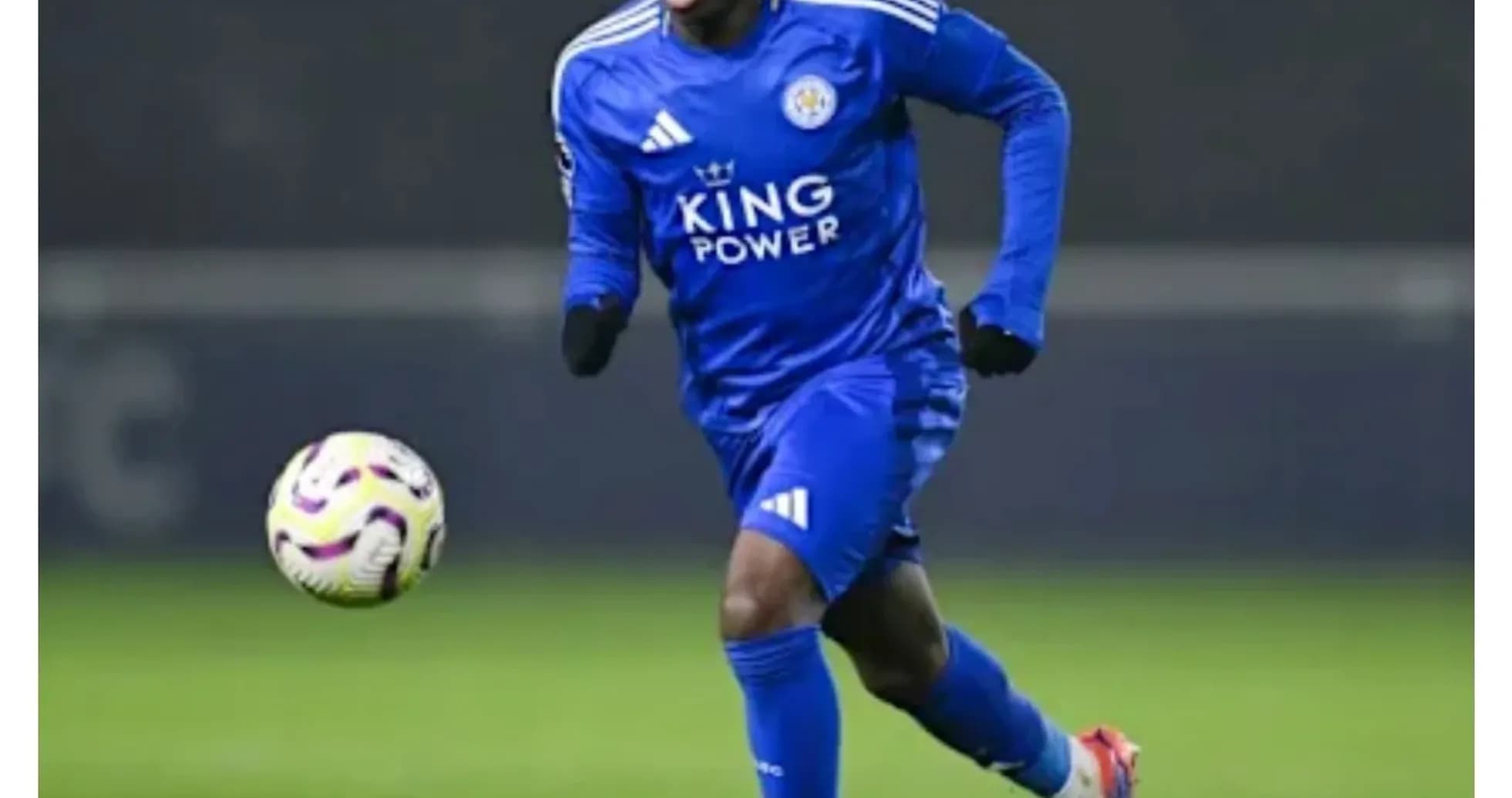Player in blue kit dribbling the ball on field Player in blue kit dribbling the ball on field