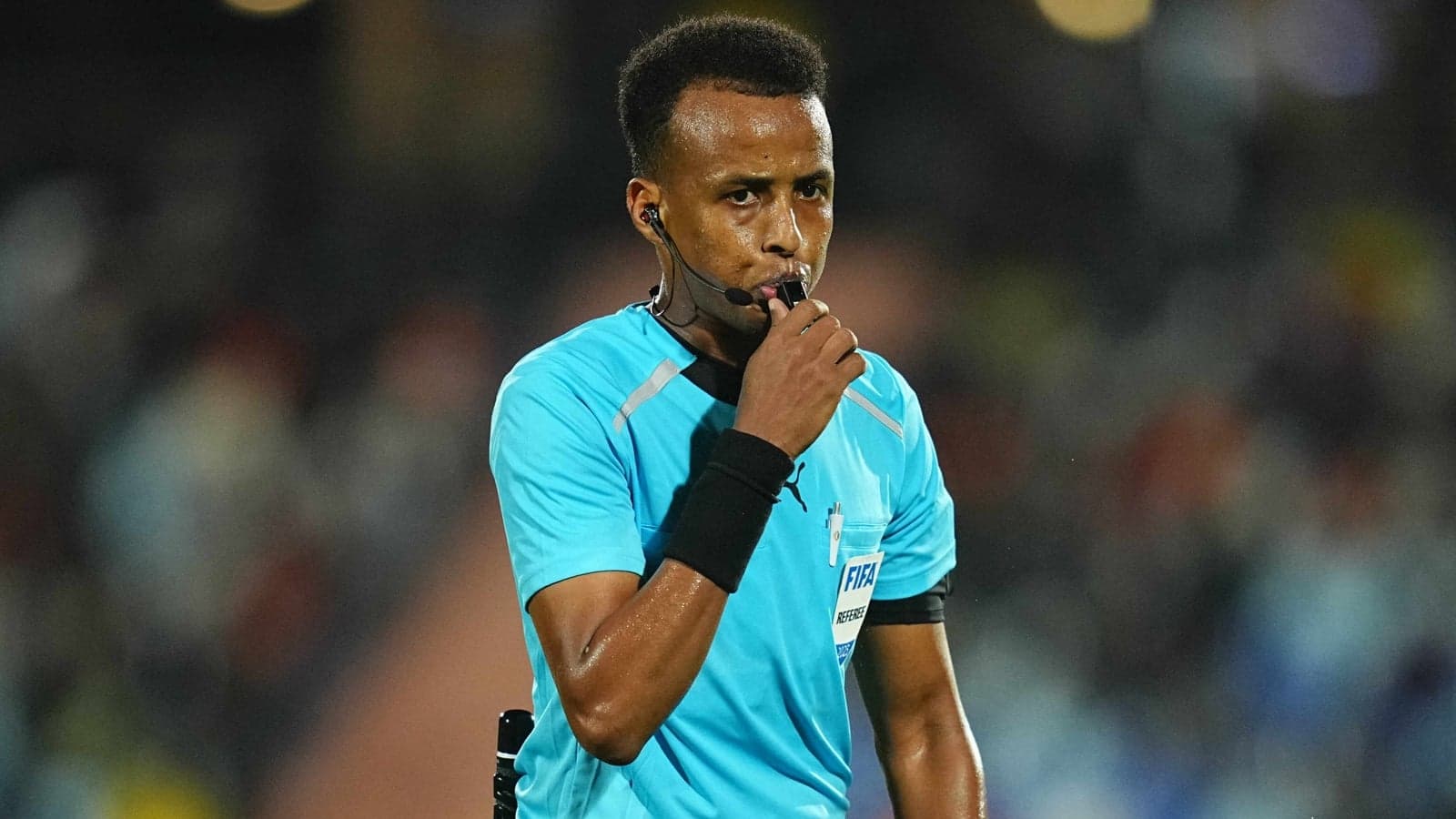 Referee blowing whistle during a match Referee blowing whistle during a match