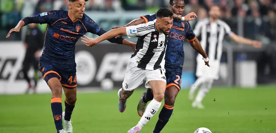 Juventus player dribbling past Lecce defenders Juventus player dribbling past Lecce defenders