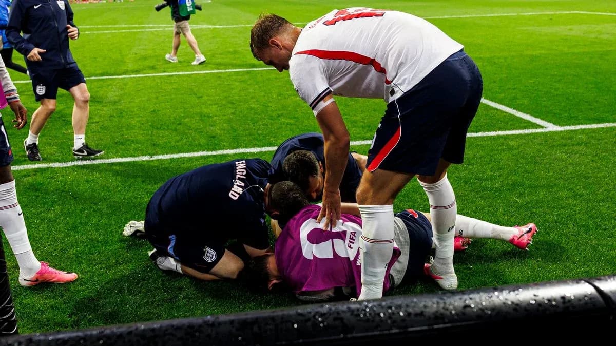 Players assisting injured teammate on the field Players assisting injured teammate on the field