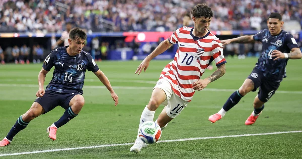 Christian Pulisic dribbling past defenders during match Christian Pulisic dribbling past defenders during match