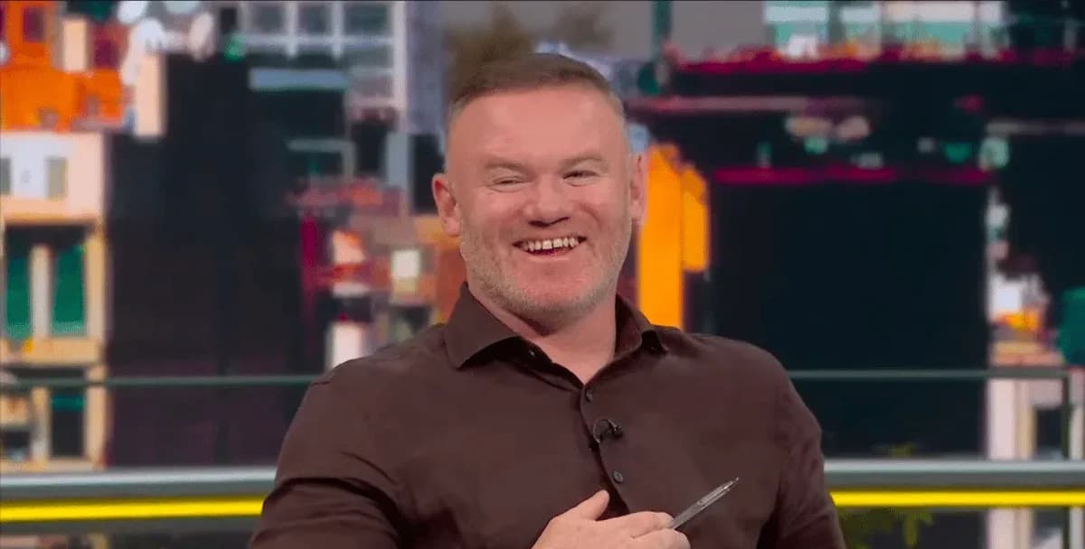Presenter smiling while holding a pen on set Presenter smiling while holding a pen on set