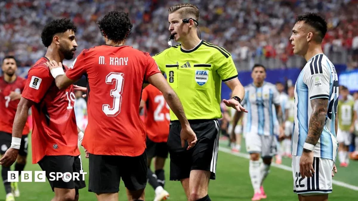 Players discussing with referee during intense match Players discussing with referee during intense match