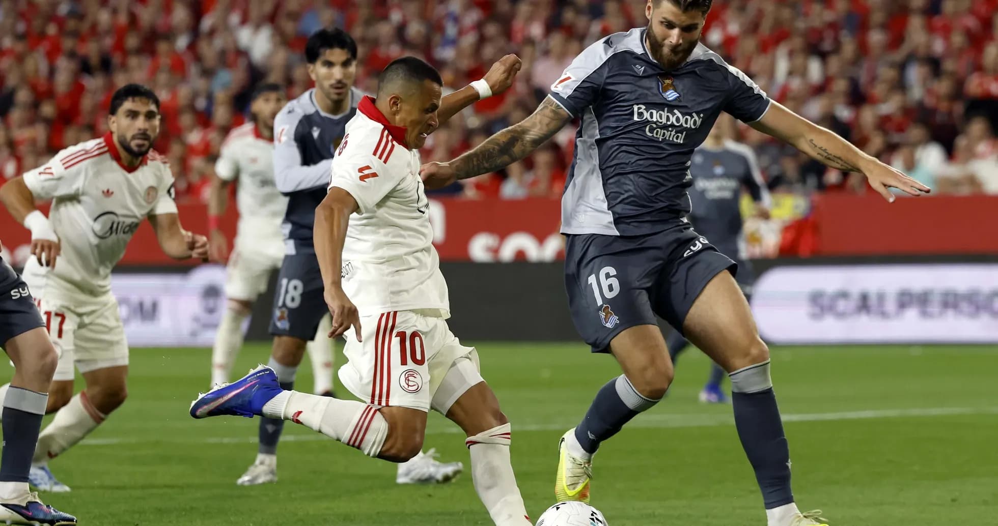 Sevilla player tackling Real Sociedad opponent Sevilla player tackling Real Sociedad opponent