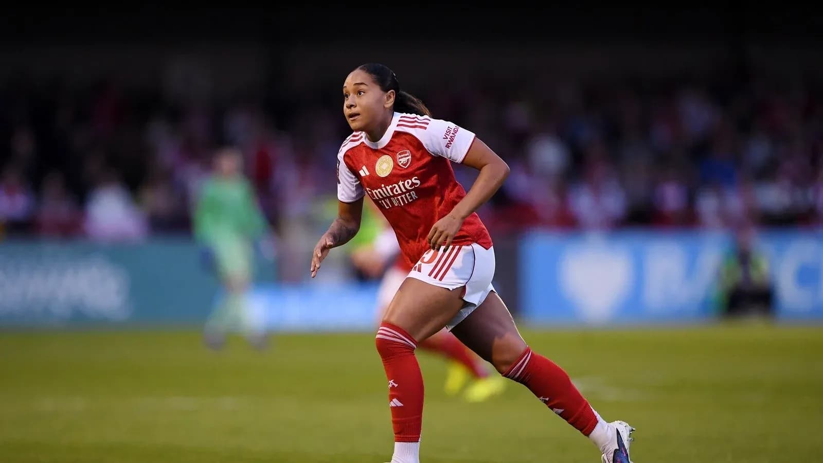 Player running on the pitch in Arsenal kit Player running on the pitch in Arsenal kit