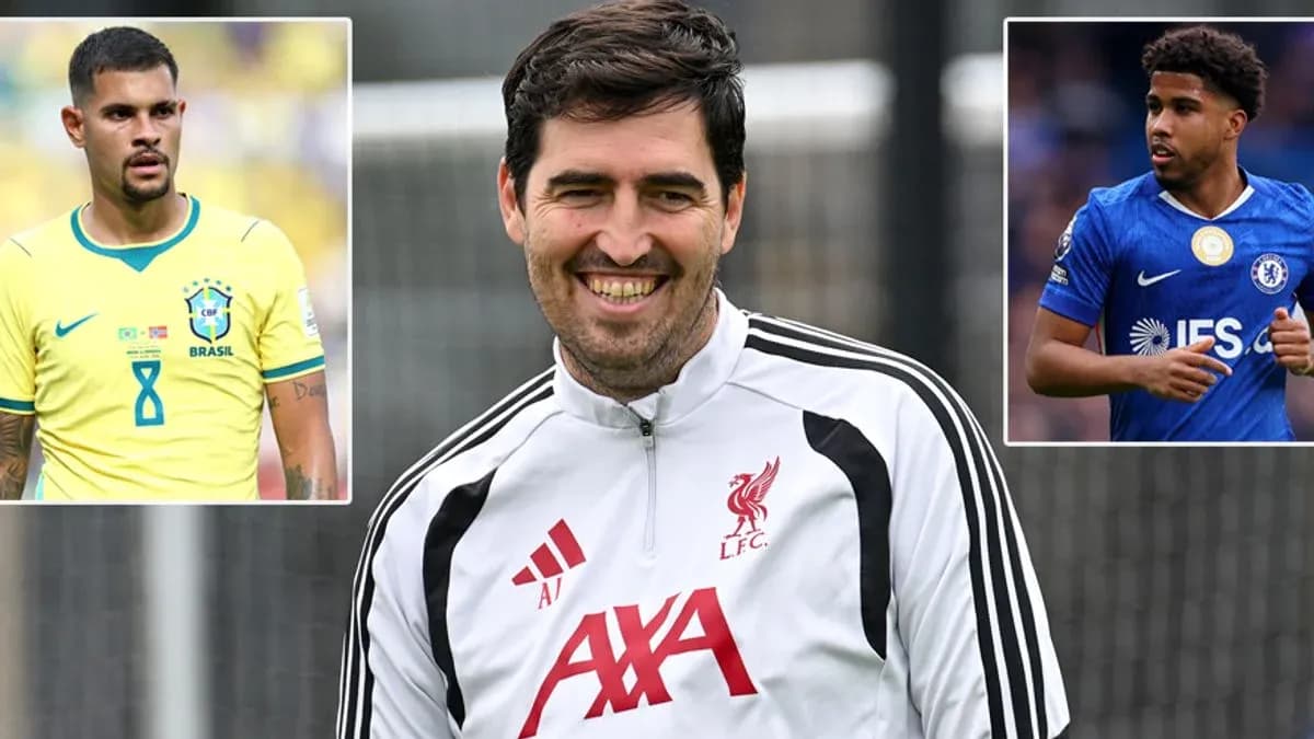 Liverpool coach smiling with players' images beside him Liverpool coach smiling with players' images beside him