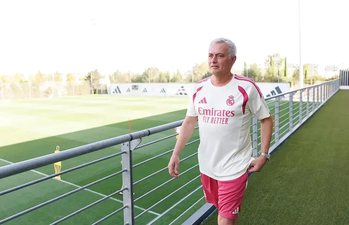 Coach walking along training pitch at facility Coach walking along training pitch at facility