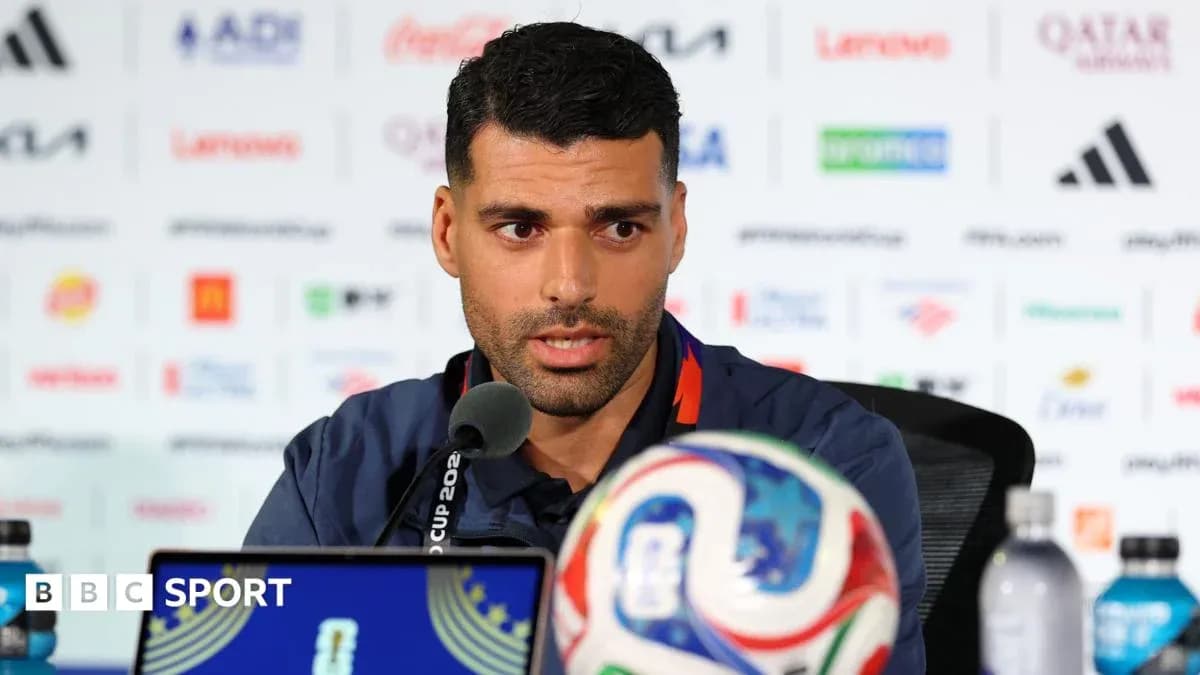 Player speaking at press conference with soccer ball Player speaking at press conference with soccer ball