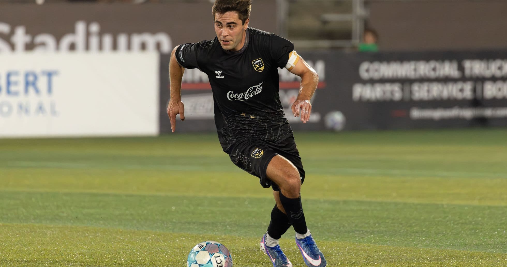 Player running with ball during football match Player running with ball during football match