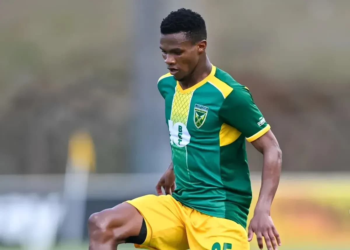 Player in green and yellow uniform during match Player in green and yellow uniform during match