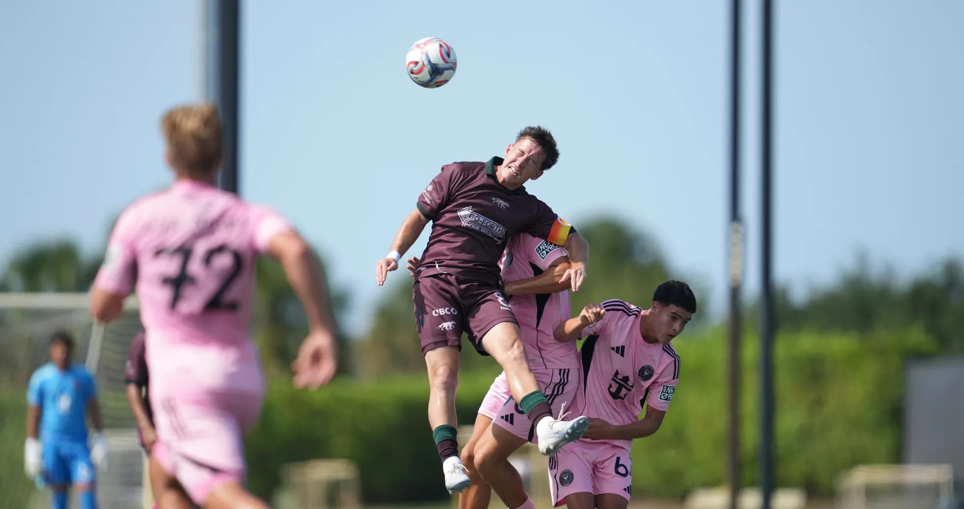 Player heading the ball during match action Player heading the ball during match action
